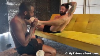 Un mec athlétique branle sa bite pendant que ses orteils sont sucés